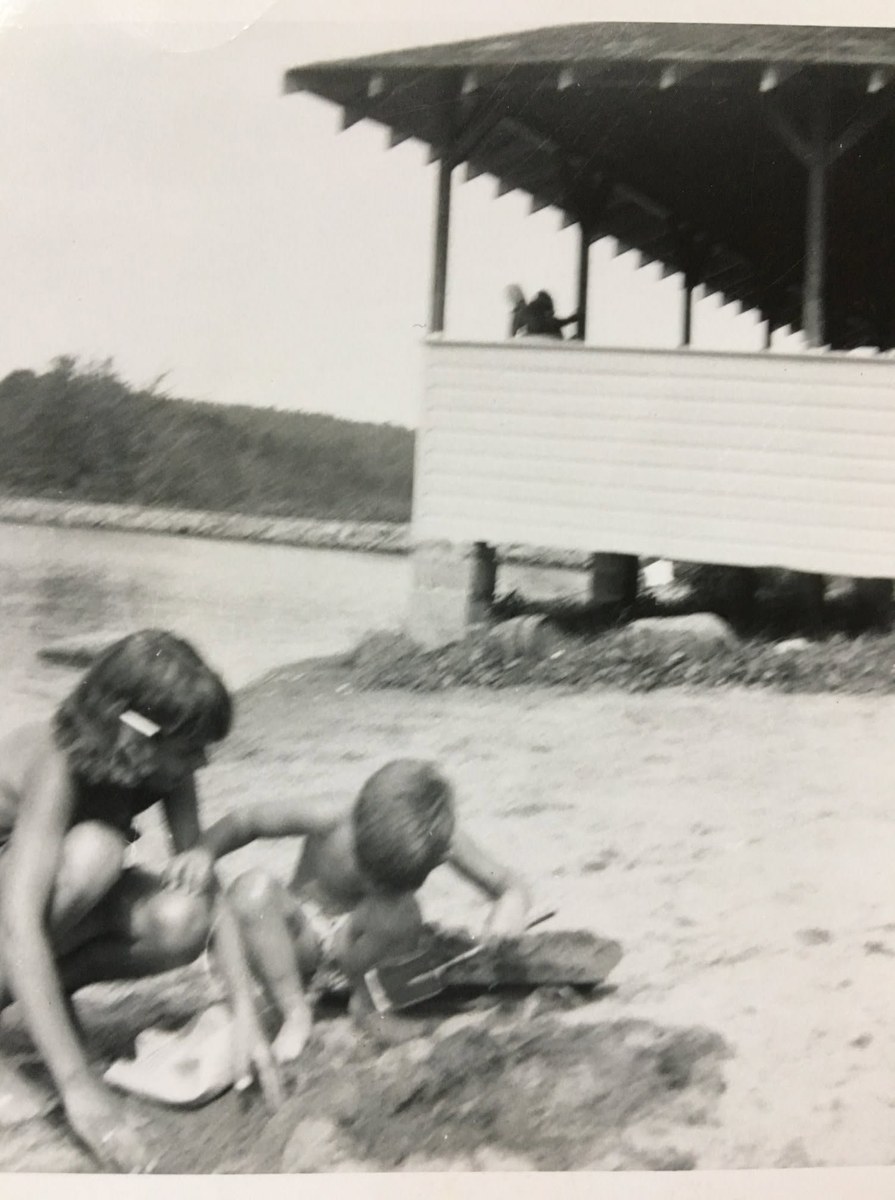 Children playing at the Sparta Lake beach beside the pavilion around 1955