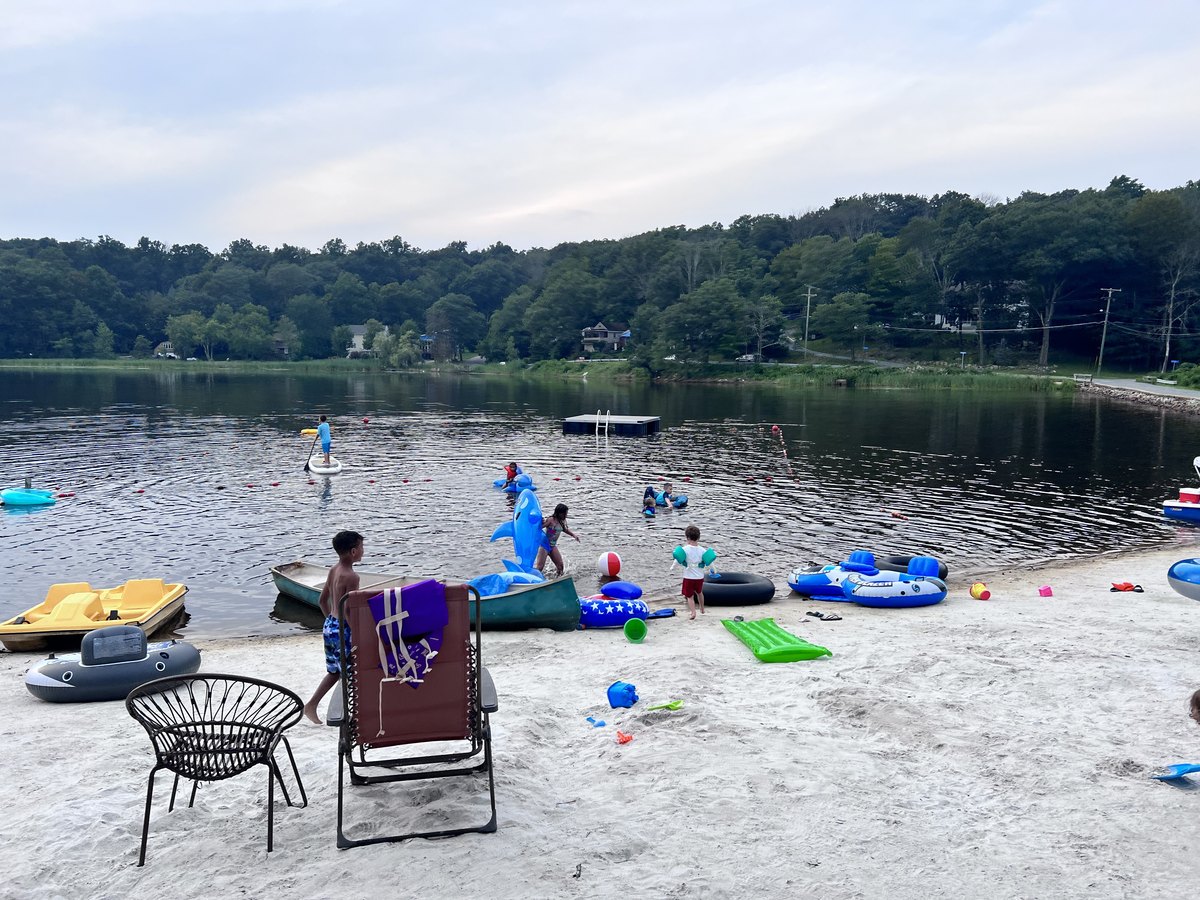 Children swimming and playing at the Sparta Lake beach in recent years