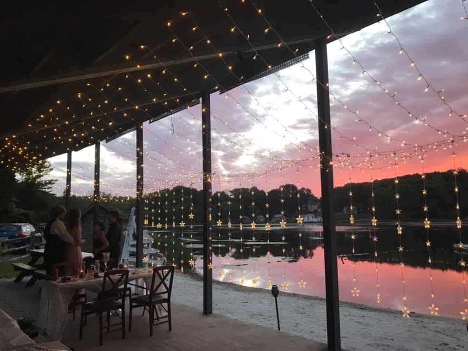 The Sparta Lake pavilion and shoreline decorated with lights at sunset